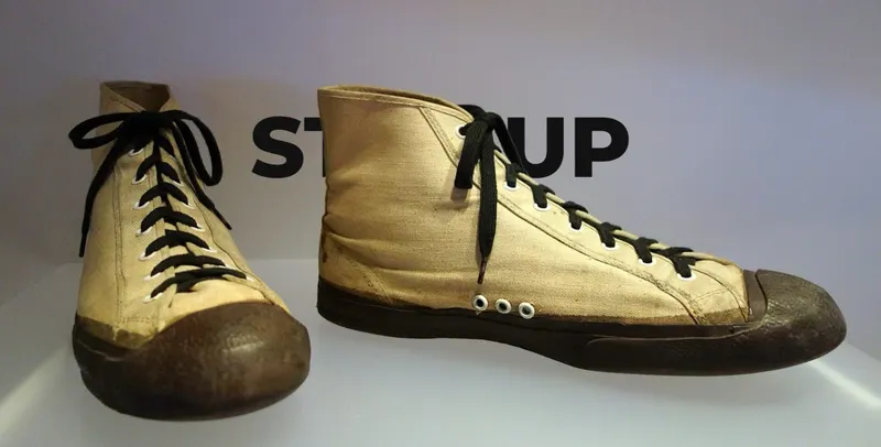 Canvas high-top sneaker with STEP UP in black Montserrat letters behind it